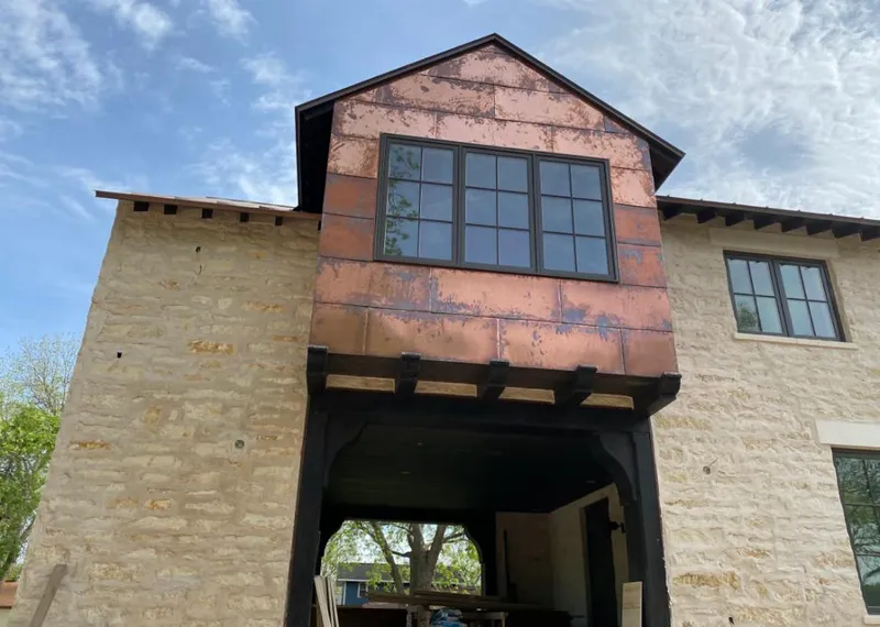 Copper metal panel facade on a stone building for Skylight Installation in North Chicago