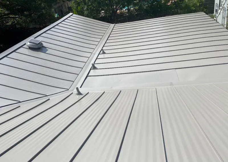 Solar attic fan installed on a metal roof for Roof Ventilation in North Chicago