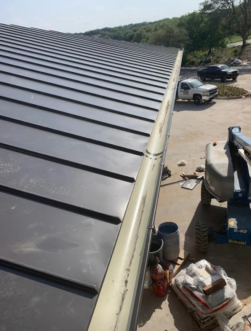 Standing seam panel and gutter detail on a metal roofing jobsite in North Chicago